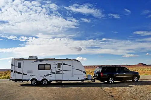 rv trailer with black car